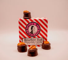 Rebecca Ruth Chocolates Bourbon Ball Chocolate Canyons with a red and white striped box on a beige background