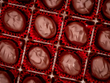 Bourbon Truffles in red wrappers arranged in a grid pattern